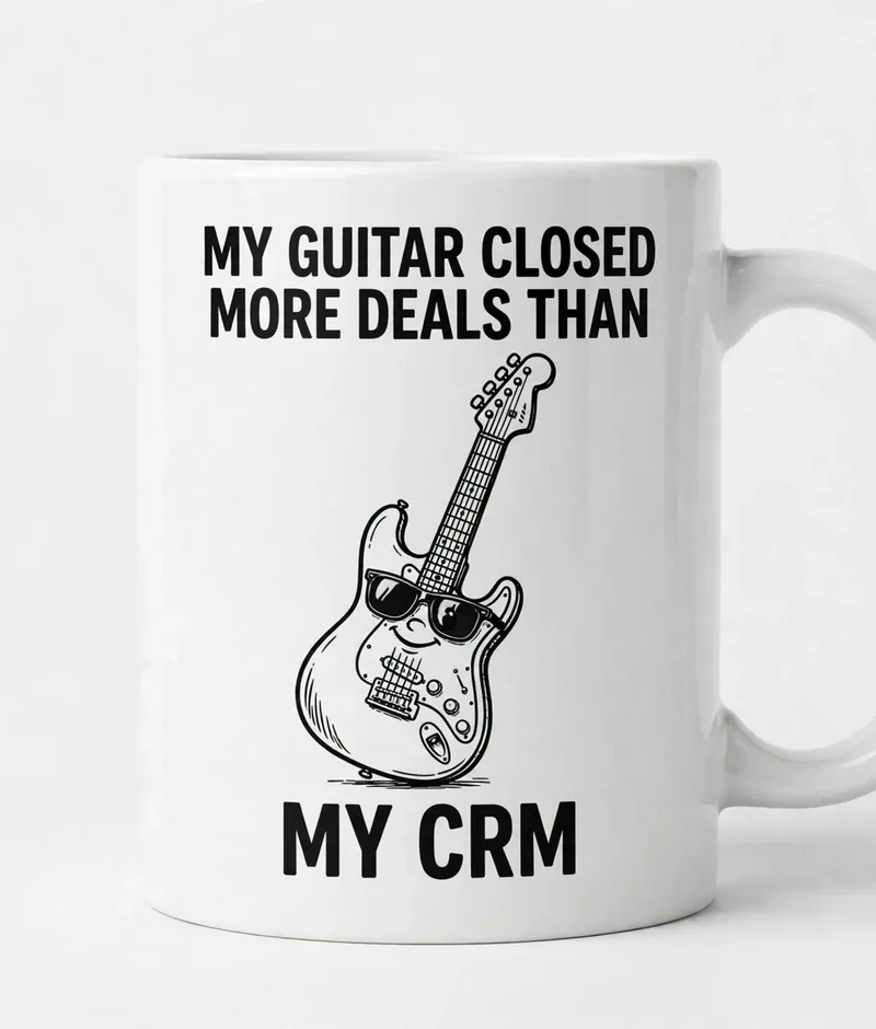 Guitar Closes Deals mug — white ceramic mug with a cartoon guitar in sunglasses